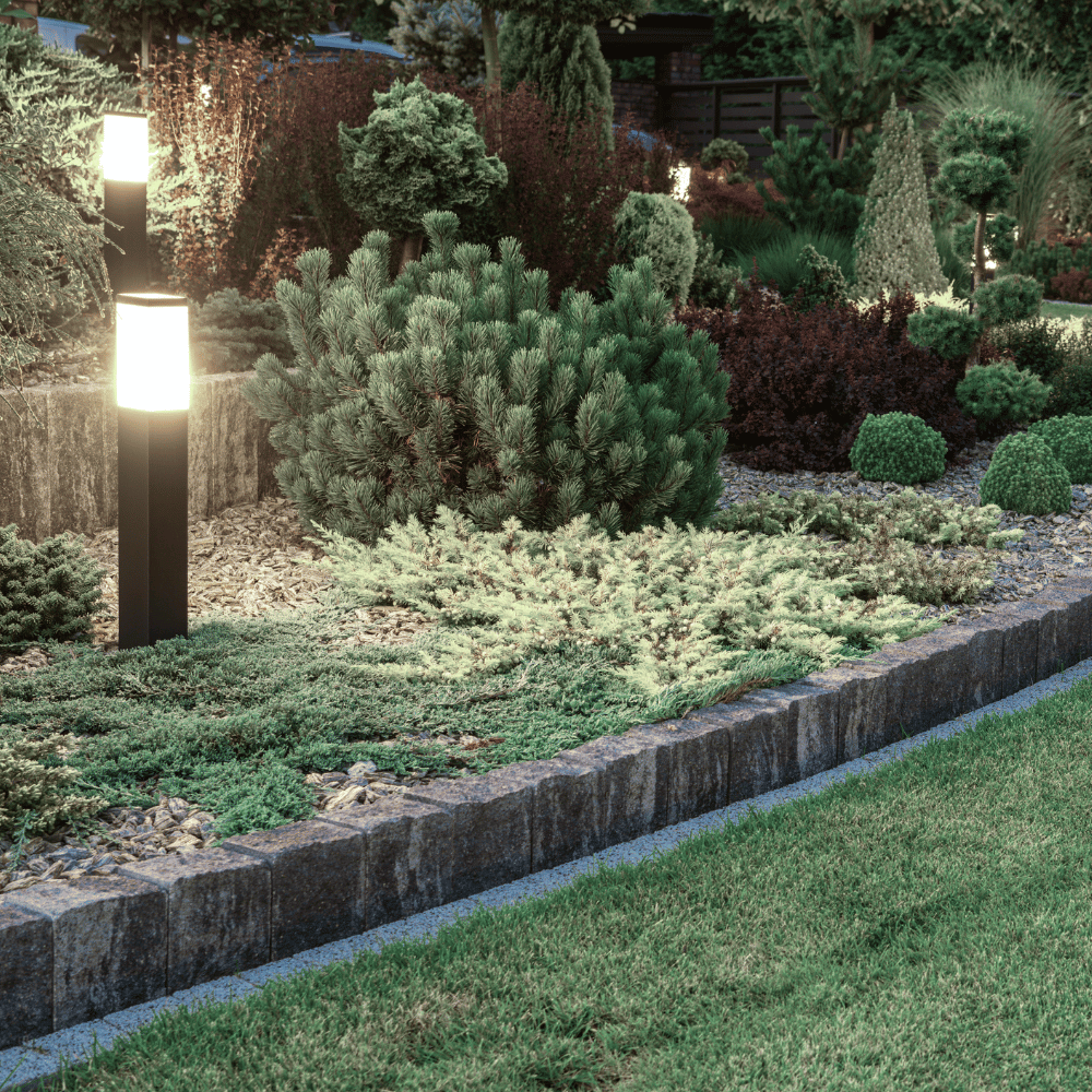 A nicely landscaped bed with small light posts