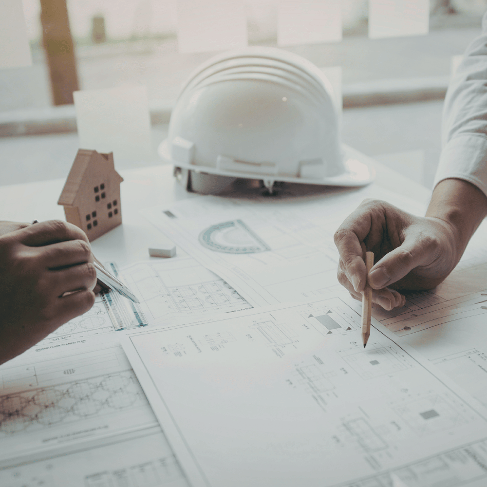 Blueprints and plans with a white hard hat
